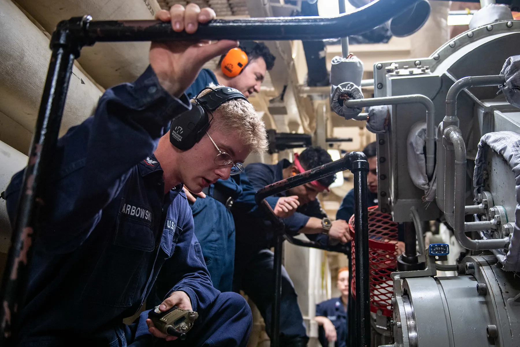 team of engineers working on heavy machinery together